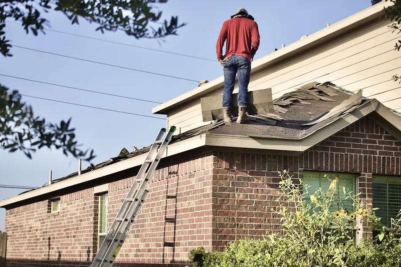 Professional roofer working on a residential roof in Hollymead